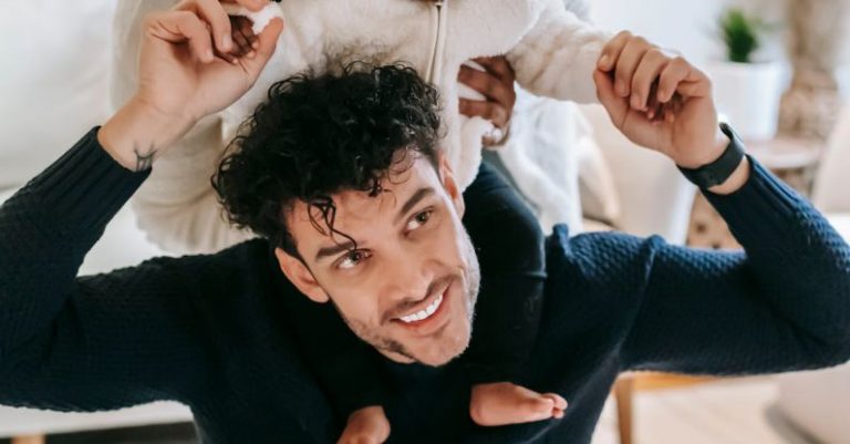 Positive Culture - Happy Muslim mother embracing black baby sitting on father