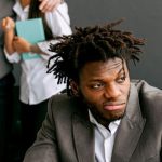 Office Politics - Frustrated Office Worker with his Colleague Laughing Behind his Back