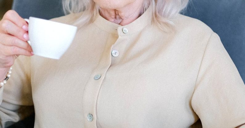 Freelance Brand - Aged woman with cup of coffee with modern convenient laptop