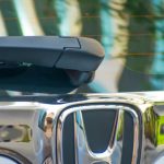 Brand Evaluation - The honda logo on the front of a car