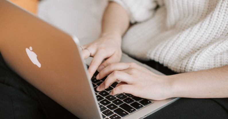 Freelance Search - Crop woman typing on laptop on bed