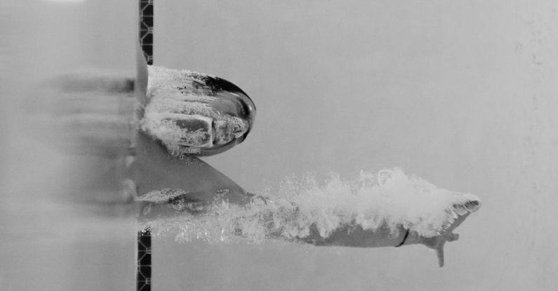Challenges Overcome - Person Swimming at the Pool in Grayscale Photo