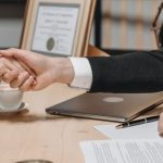 Contract Negotiation - People Shaking Their Hands in Close Deal Business Contract