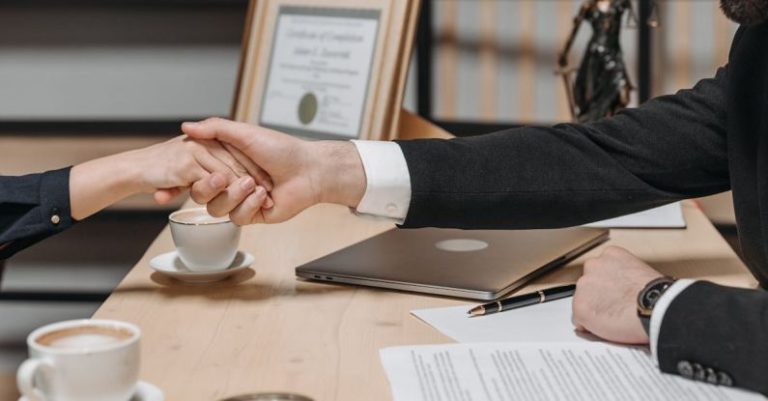 Contract Negotiation - People Shaking Their Hands in Close Deal Business Contract