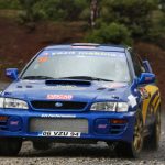 Competition Race - A rally car is driving on a gravel road