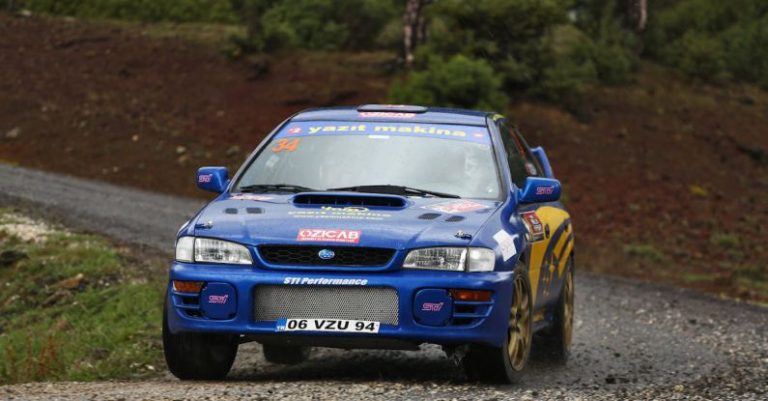 Competition Race - A rally car is driving on a gravel road