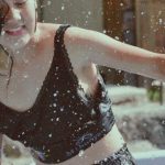 Action Verbs - A girl in a black top and shorts splashing water