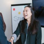 Networking Handshake - Woman in Black Blazer Smiling