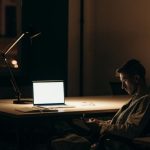 Online Networking - Man in Black and White Stripe Dress Shirt Sitting on Chair in Front of Macbook