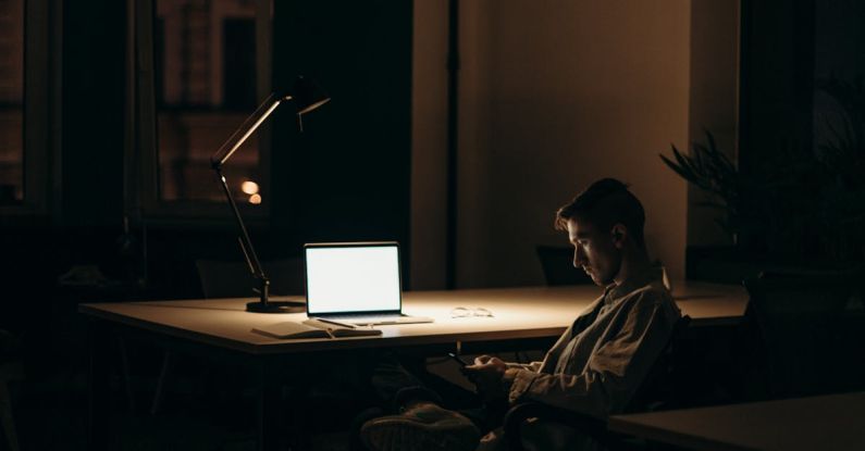 Online Networking - Man in Black and White Stripe Dress Shirt Sitting on Chair in Front of Macbook