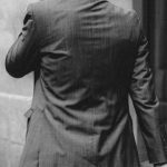 Career Paths - Elegant businessman in suit walking along concrete building