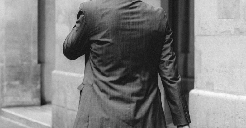 Career Paths - Elegant businessman in suit walking along concrete building