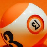 Learning Combination - Billiard ball with number on bright orange surface for complex intellectual board game