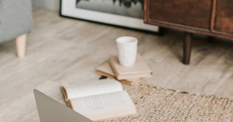 Remote Work Future - Laptop and books on floor carpet
