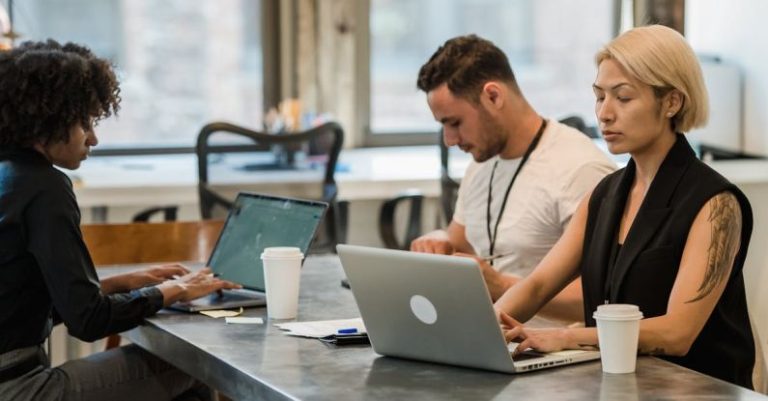 Diversity Inclusion - Group of People Sitting at Table and Working on Laptops